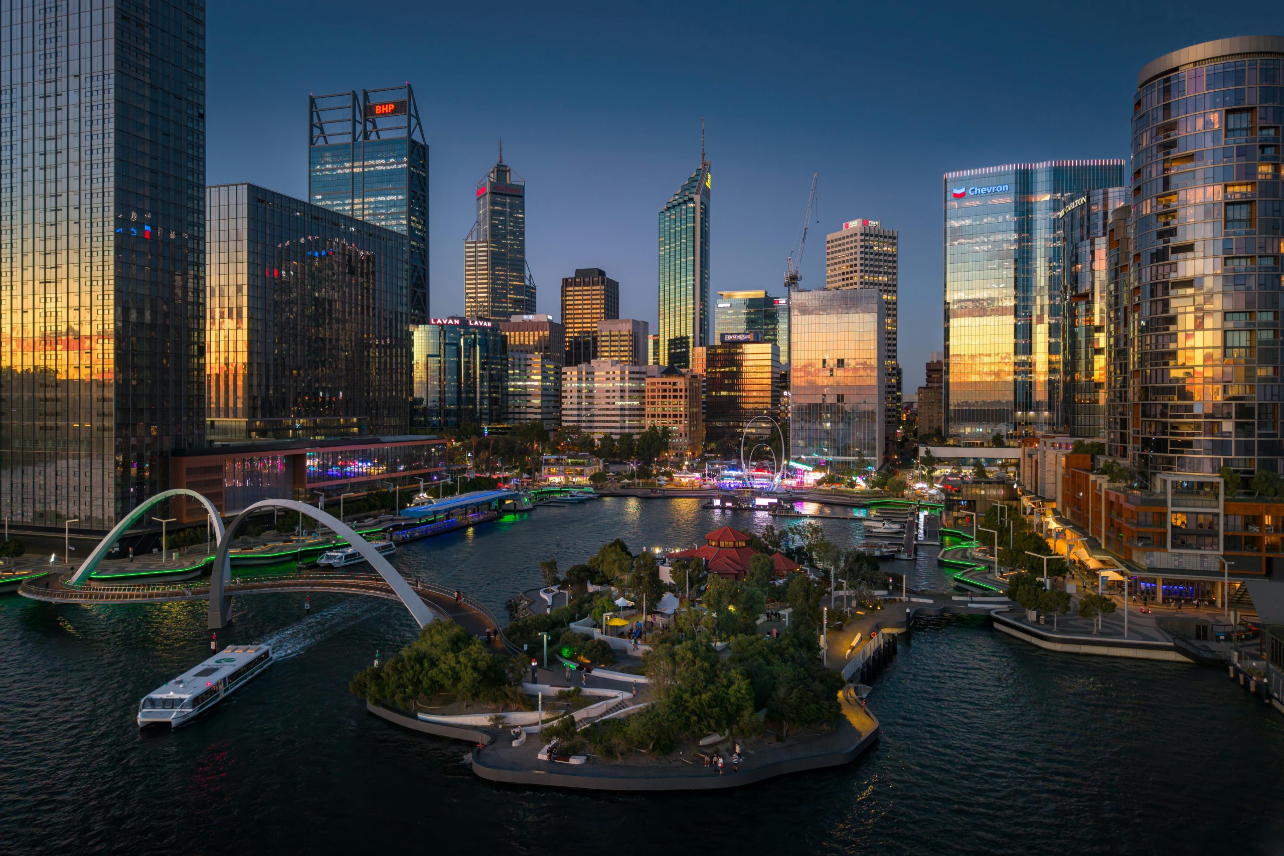 Explore the dynamic skyline of Perth reflecting city life at sunset over the Swan River.